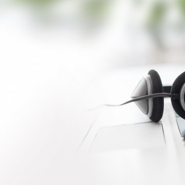 axvoice review voip service laptop and headset on the keyboard